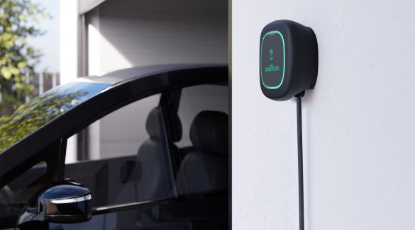 Zoomed-in shot of Nissan ARIYA near a charging cable, not plugged in | Chico Nissan in Chico CA