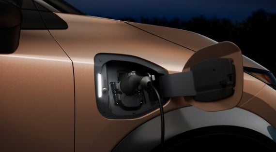 Close-up image of charging cable plugged in | Chico Nissan in Chico CA